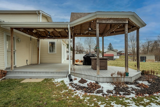 exterior space with a yard, a grill, ceiling fan, and a wooden deck