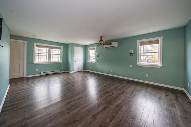 unfurnished room featuring plenty of natural light, dark wood-style flooring, a wall unit AC, and a baseboard radiator