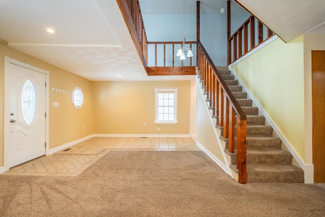 tiled entrance foyer featuring carpet floors, recessed lighting, stairway, a chandelier, and baseboards