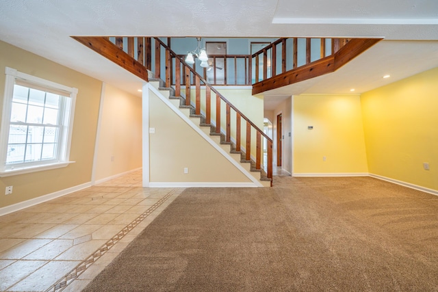 unfurnished living room featuring stairway, baseboards, carpet flooring, and recessed lighting