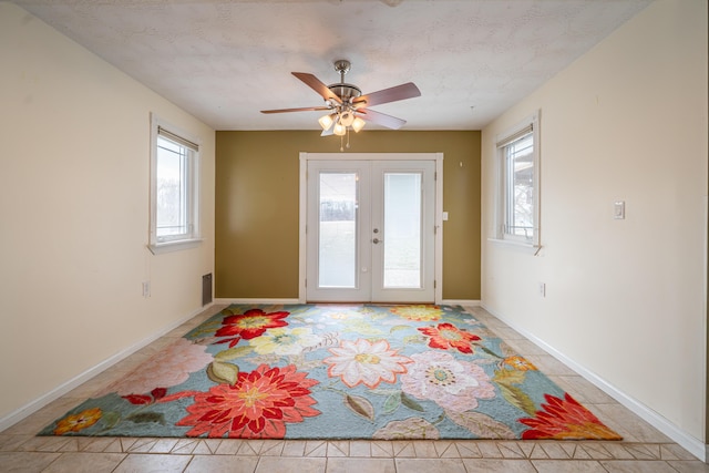 doorway to outside featuring light tile patterned floors, baseboards, a ceiling fan, and french doors