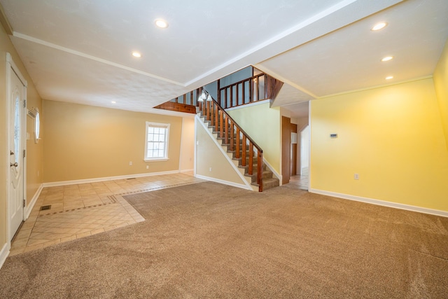 empty room featuring carpet floors, baseboards, stairway, and recessed lighting