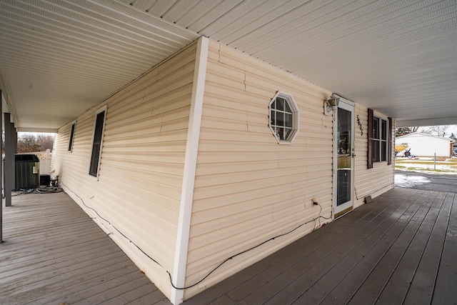 wooden deck featuring central air condition unit