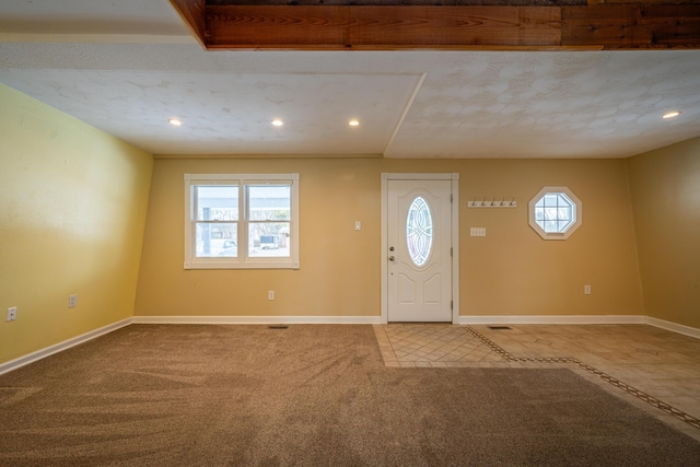 carpeted entryway featuring recessed lighting and baseboards