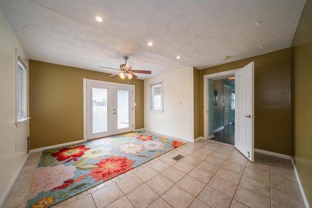 interior space featuring light tile patterned floors, recessed lighting, visible vents, baseboards, and french doors