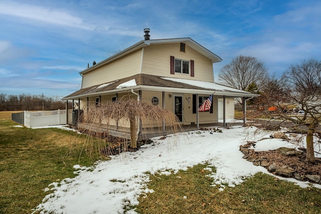 exterior space featuring covered porch, a yard, and fence