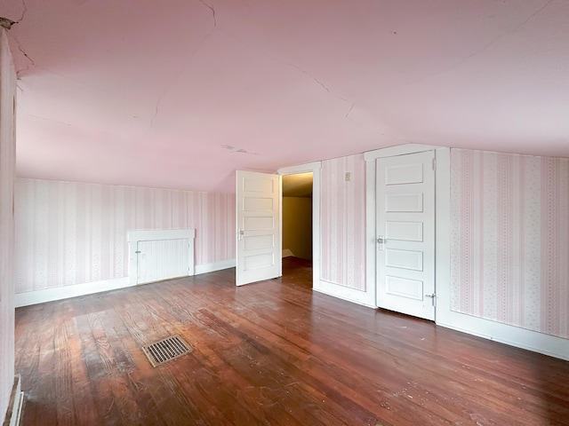 308 E Xenia Dr, Fairborn, OH 45324 - additional living space with visible vents, baseboards, wood finished floors, wallpapered walls, and lofted ceiling