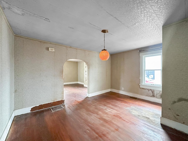 308 E Xenia Dr, Fairborn, OH 45324 - spare room featuring visible vents, arched walkways, wood finished floors, and a textured ceiling