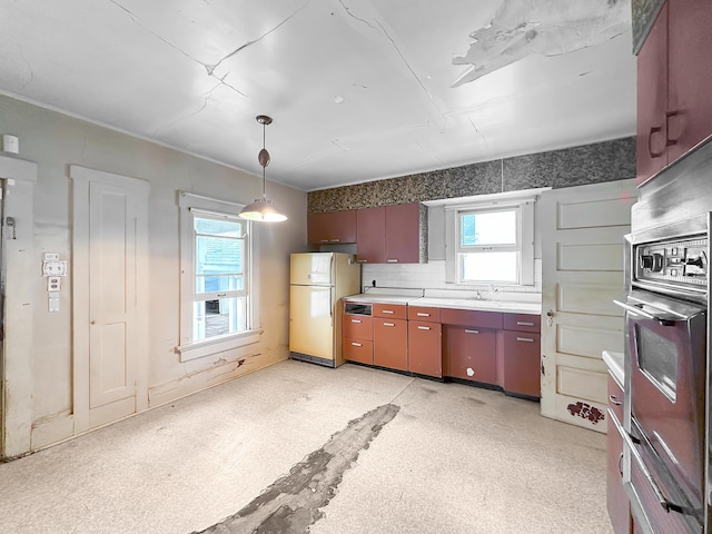 308 E Xenia Dr, Fairborn, OH 45324 - kitchen with freestanding refrigerator, stainless steel oven, light countertops, hanging light fixtures, and backsplash