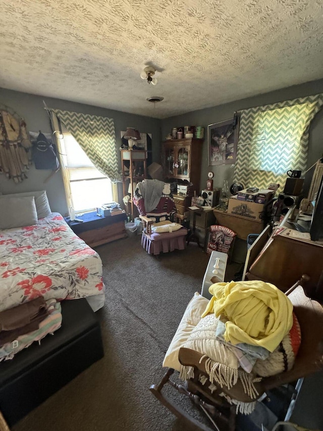 bedroom with a textured ceiling and carpet floors