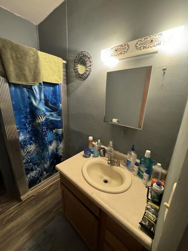 bathroom with wood finished floors and vanity