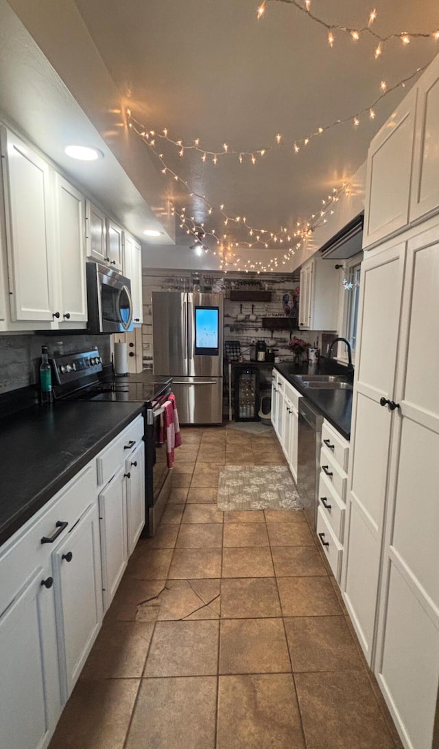 kitchen featuring white cabinetry, sink, decorative backsplash, and stainless steel appliances