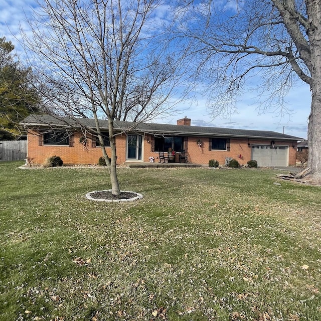 view of front of home featuring a garage and a front lawn