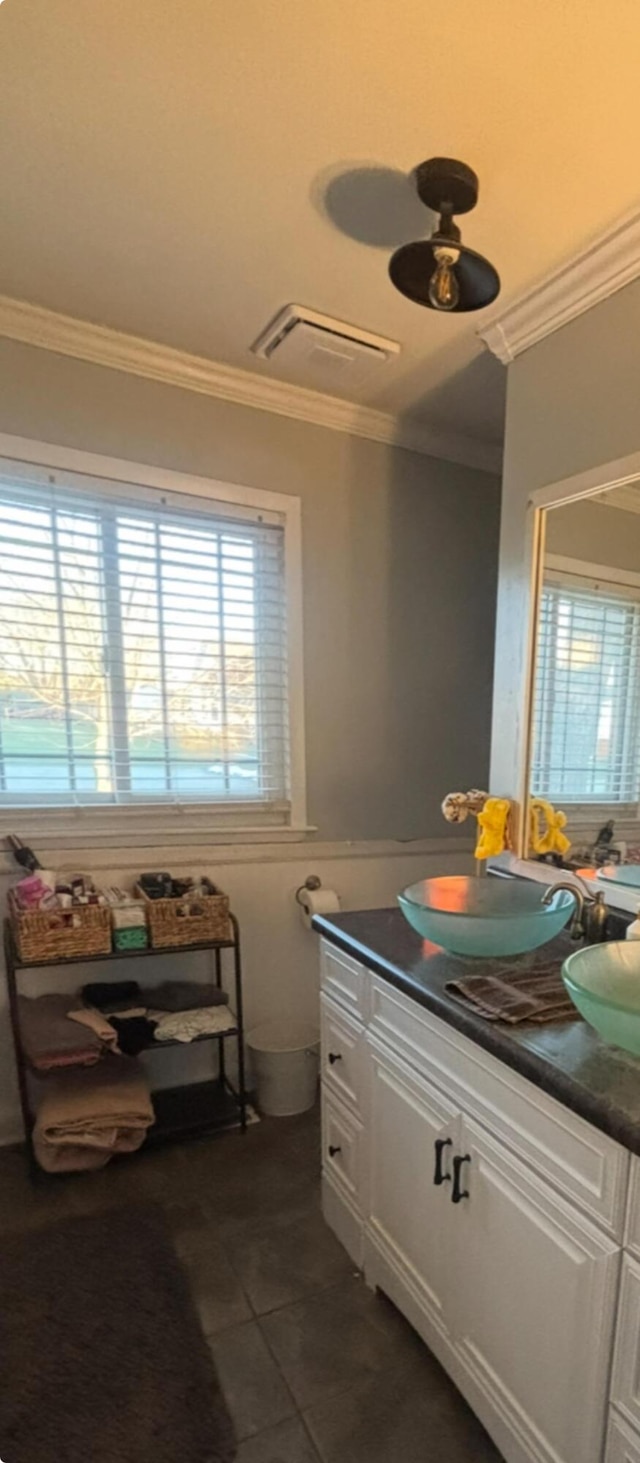 bathroom with crown molding, vanity, and tile patterned flooring