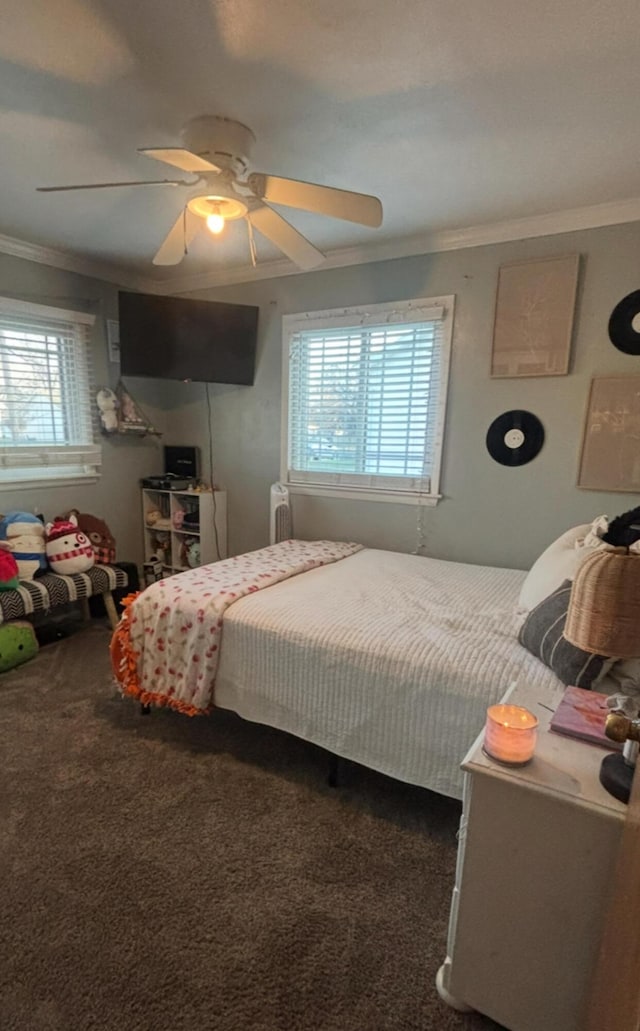 bedroom featuring ceiling fan, ornamental molding, and carpet floors