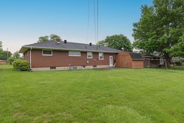 4833 Mesa Ln, Springfield, OH 45503 - rear view of house with a storage shed, a yard, a chimney, a patio, and brick siding