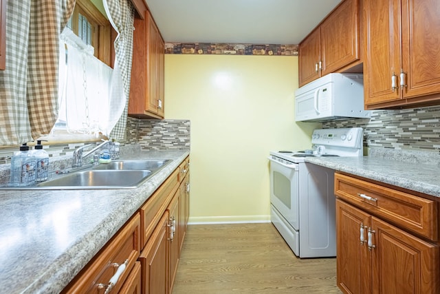 4833 Mesa Ln, Springfield, OH 45503 - kitchen with white appliances, light wood-style floors, brown cabinets, and decorative backsplash