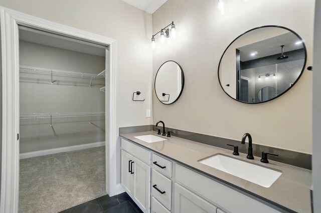 1505 Kingsgate Rd, Springfield, OH 45503 - bathroom featuring double vanity, walk in shower, a spacious closet, baseboards, and tile patterned floors