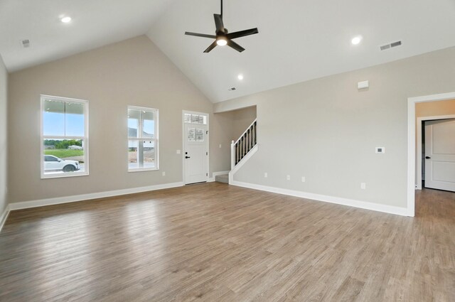 1505 Kingsgate Rd, Springfield, OH 45503 - unfurnished living room with a ceiling fan, high vaulted ceiling, stairs, light wood finished floors, and baseboards