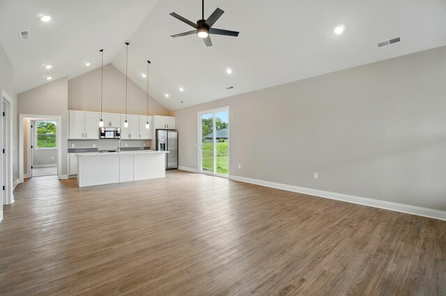 1505 Kingsgate Rd, Springfield, OH 45503 - unfurnished living room featuring high vaulted ceiling, ceiling fan, light wood-style floors, recessed lighting, and baseboards