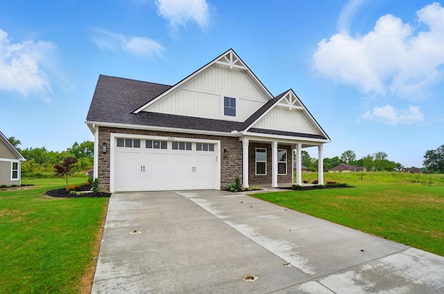 1505 Kingsgate Rd, Springfield, OH 45503 - view of front facade with concrete driveway, a front yard, a porch, and stone siding
