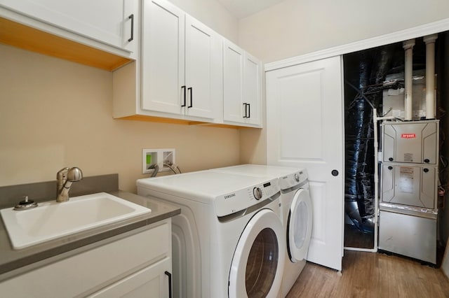 1505 Kingsgate Rd, Springfield, OH 45503 - laundry area with washer and clothes dryer, cabinet space, and light wood-type flooring