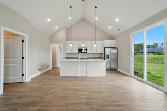 1505 Kingsgate Rd, Springfield, OH 45503 - kitchen featuring appliances with stainless steel finishes, a sink, high vaulted ceiling, light countertops, and white cabinetry