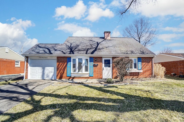 view of front of house with brick siding, aphalt driveway, a front yard, a chimney, and an attached garage