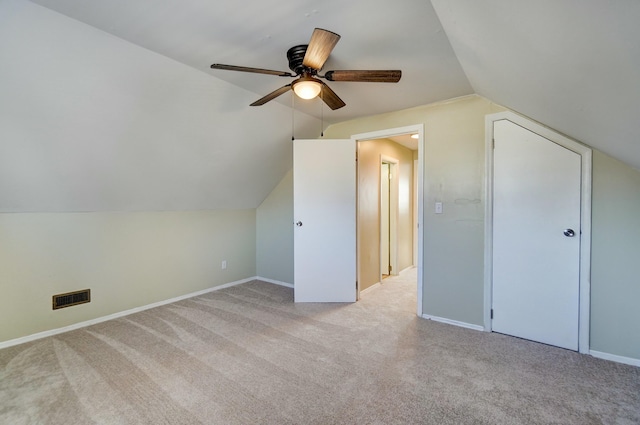 additional living space featuring visible vents, baseboards, carpet, and vaulted ceiling