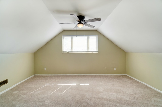 additional living space featuring baseboards, carpet floors, and lofted ceiling