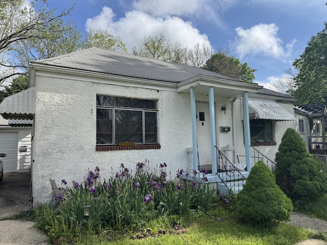 914 Mitchell Blvd, Springfield, OH 45503 - view of front of house with stucco siding, a shingled roof, and a garage
