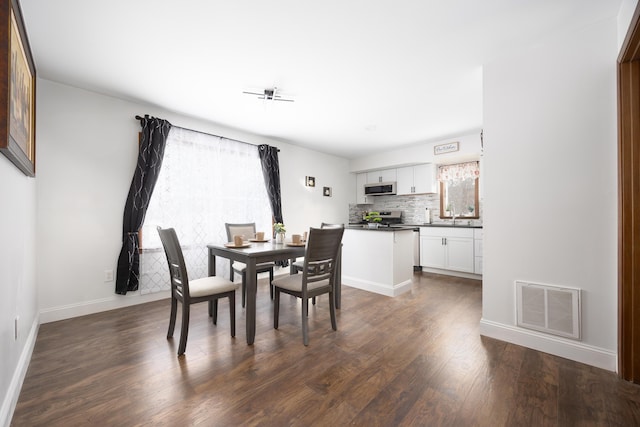 dining room featuring dark hardwood / wood-style flooring