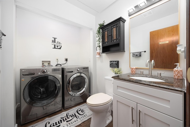 washroom with sink and washer and clothes dryer