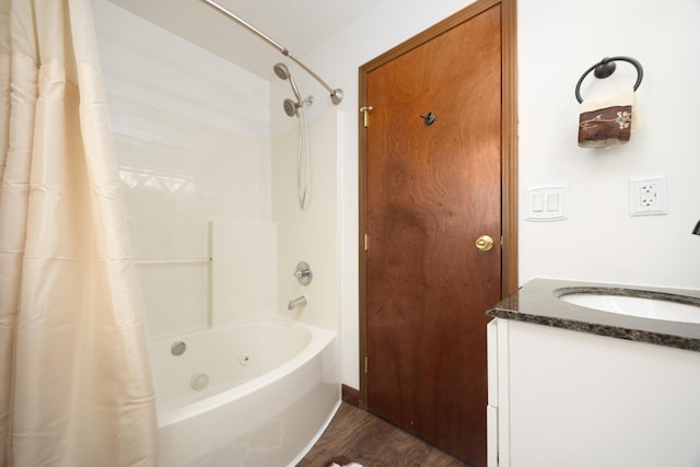 bathroom with shower / bath combo, hardwood / wood-style floors, and vanity