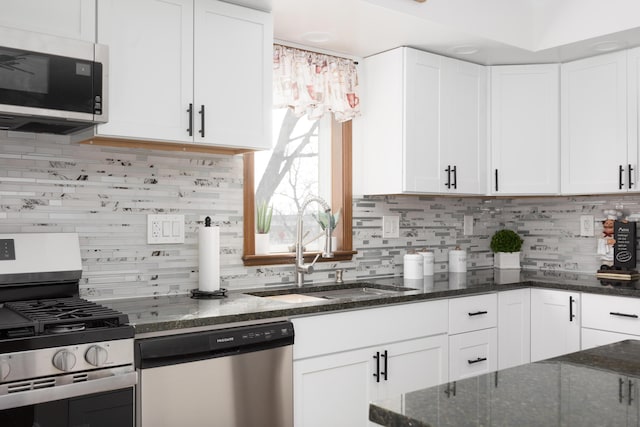 kitchen featuring tasteful backsplash, appliances with stainless steel finishes, sink, and white cabinets