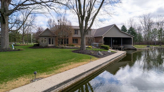 view of community featuring a lawn and a water view