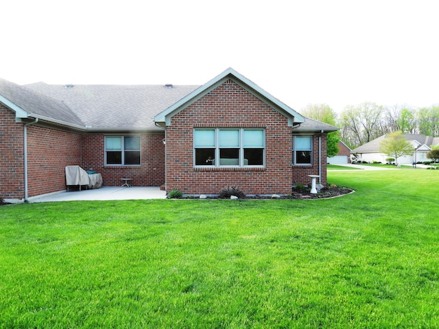 2732 Summer Field Trl, Sidney, OH 45365 - back of house with a patio area, brick siding, a yard, and roof with shingles