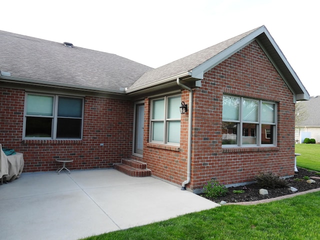 2732 Summer Field Trl, Sidney, OH 45365 - exterior space featuring brick siding, a shingled roof, a patio, and entry steps