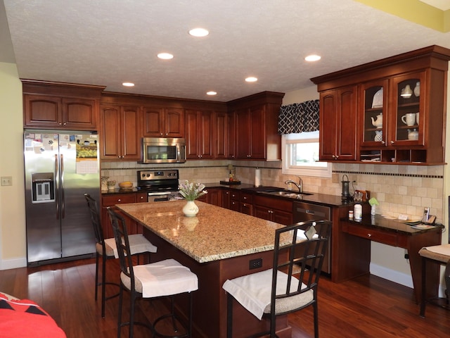 2732 Summer Field Trl, Sidney, OH 45365 - kitchen featuring stainless steel appliances, dark wood-type flooring, a kitchen island, stone counters, and recessed lighting