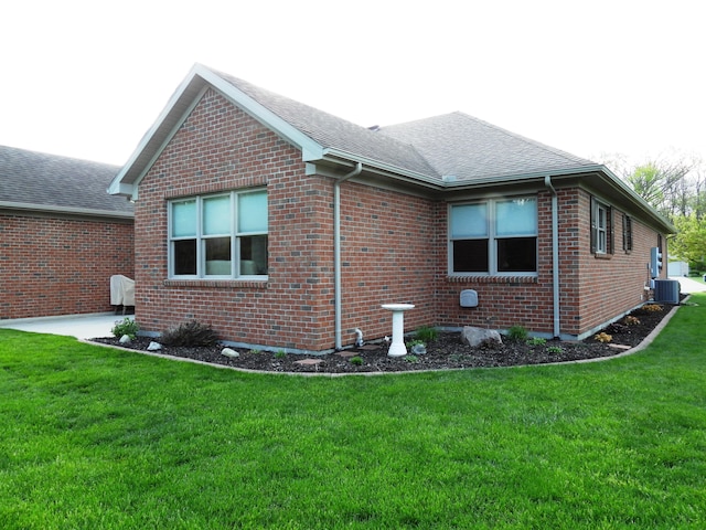 2732 Summer Field Trl, Sidney, OH 45365 - view of side of property featuring a shingled roof, brick siding, and a lawn