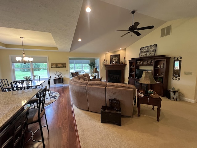 2732 Summer Field Trl, Sidney, OH 45365 - living area featuring a ceiling fan, a fireplace, a chandelier, lofted ceiling, and wood finished floors