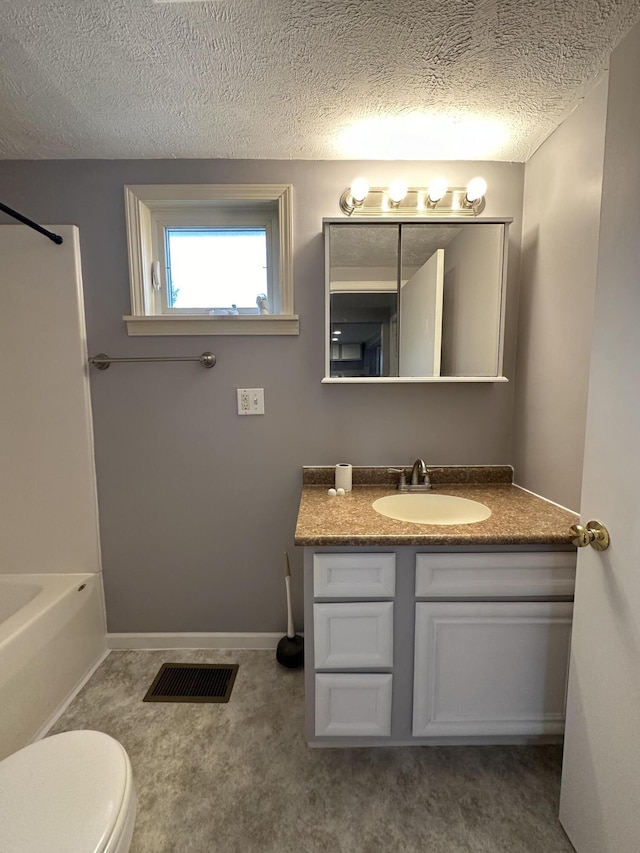 full bathroom featuring vanity, toilet, a textured ceiling, and shower / bath combination