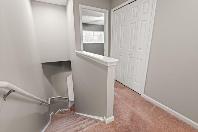 staircase with carpet floors and baseboards