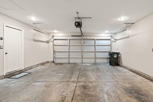 garage featuring baseboards, a garage door opener, and recessed lighting