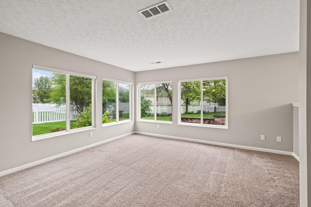 empty room with visible vents, baseboards, and carpet floors