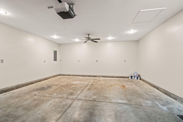 garage featuring baseboards, a garage door opener, and electric panel