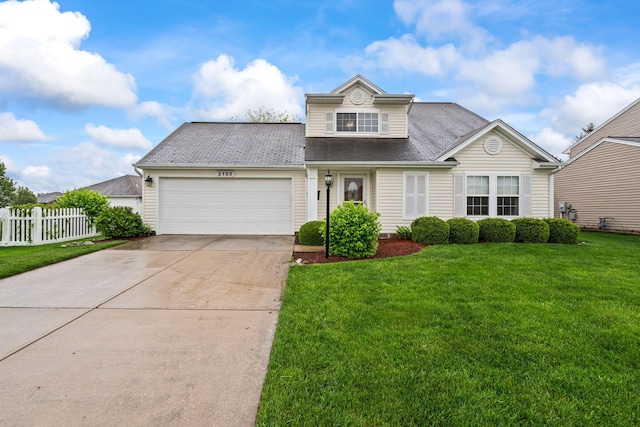 traditional-style home featuring driveway, roof with shingles, fence, a front lawn, and an attached garage