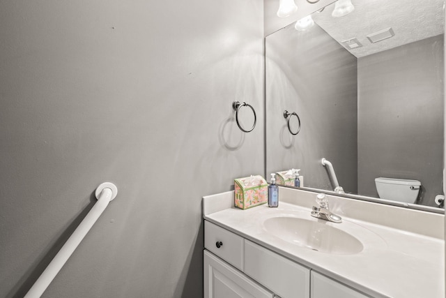 half bathroom with toilet and vanity
