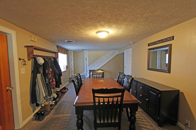 dining space featuring dark colored carpet and baseboards