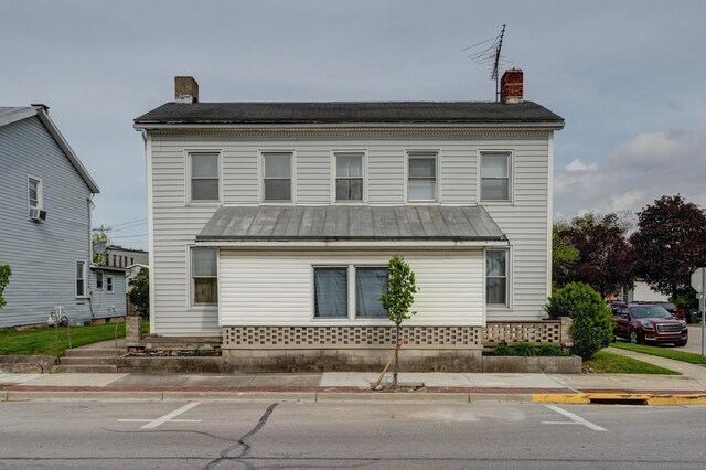 view of front of home featuring a chimney